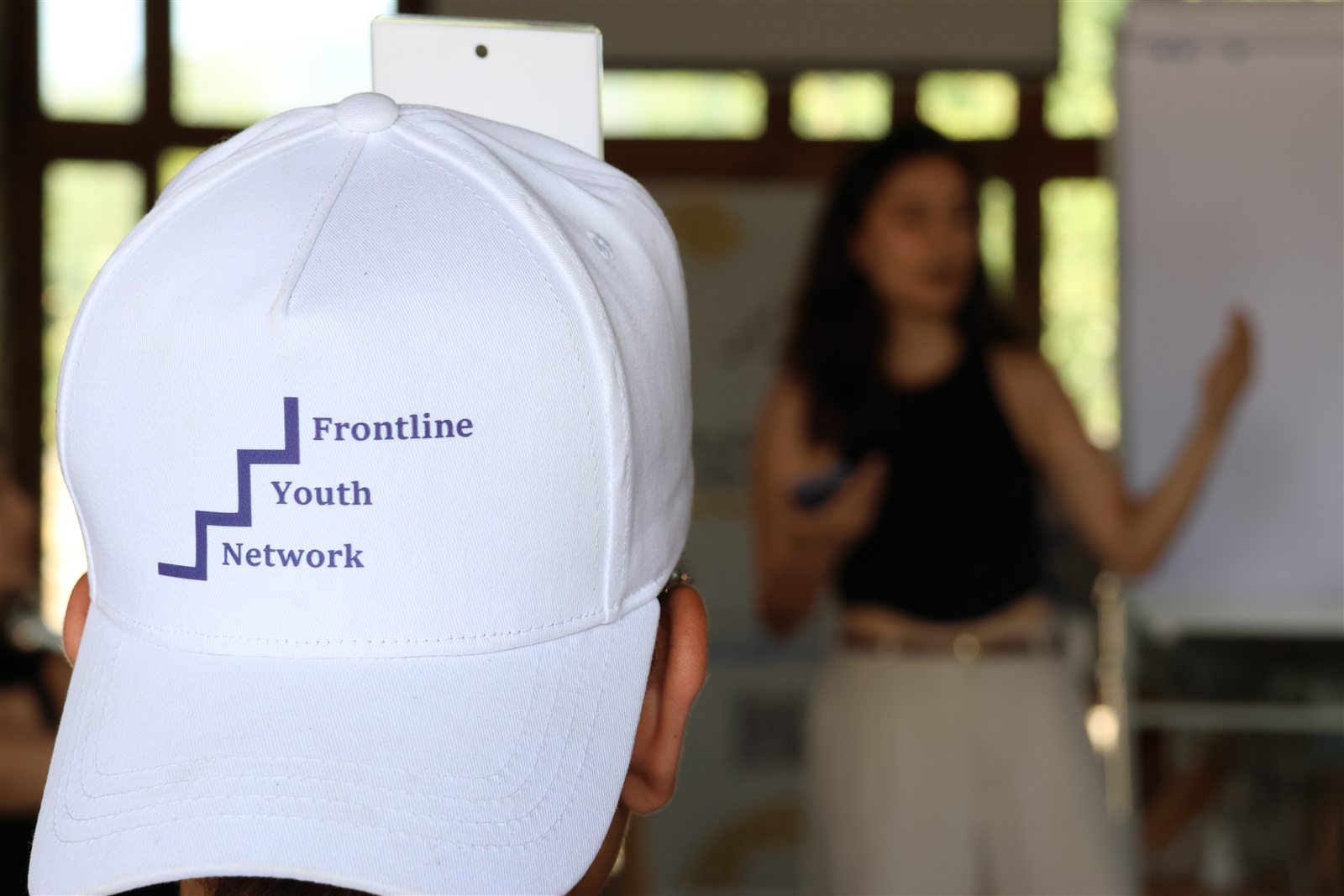 A Frontline participant listening during a facilitated education session